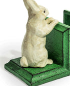 Statue of a rabbit on a green base with a white background