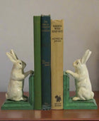 Rabbit-shaped bookends holding books on a white background