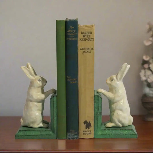 Rabbit-shaped bookends holding books on a white background
