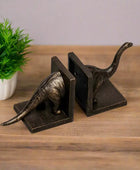 Bronze dinosaur bookends on a white background