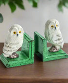 Owl-shaped bookends with green bases on a white background