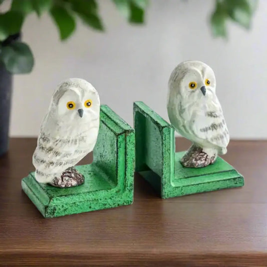 Owl-shaped bookends with green bases on a white background