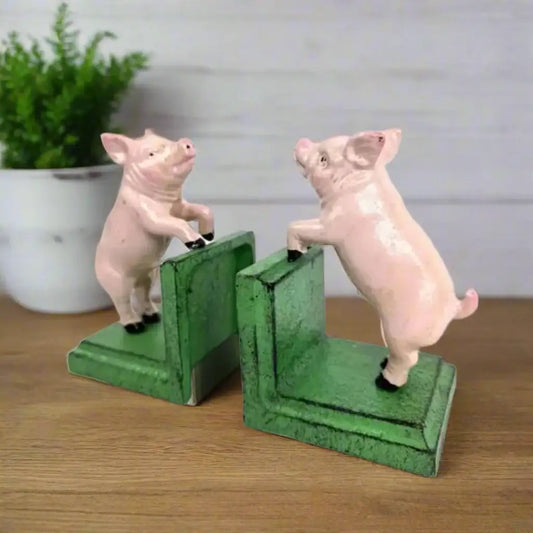 Two pig-shaped bookends on a white background