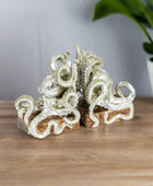Silver octopus-shaped jewelry on a white background