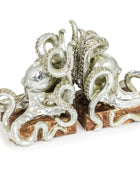 Decorative silver octopus sculpture on a wooden base