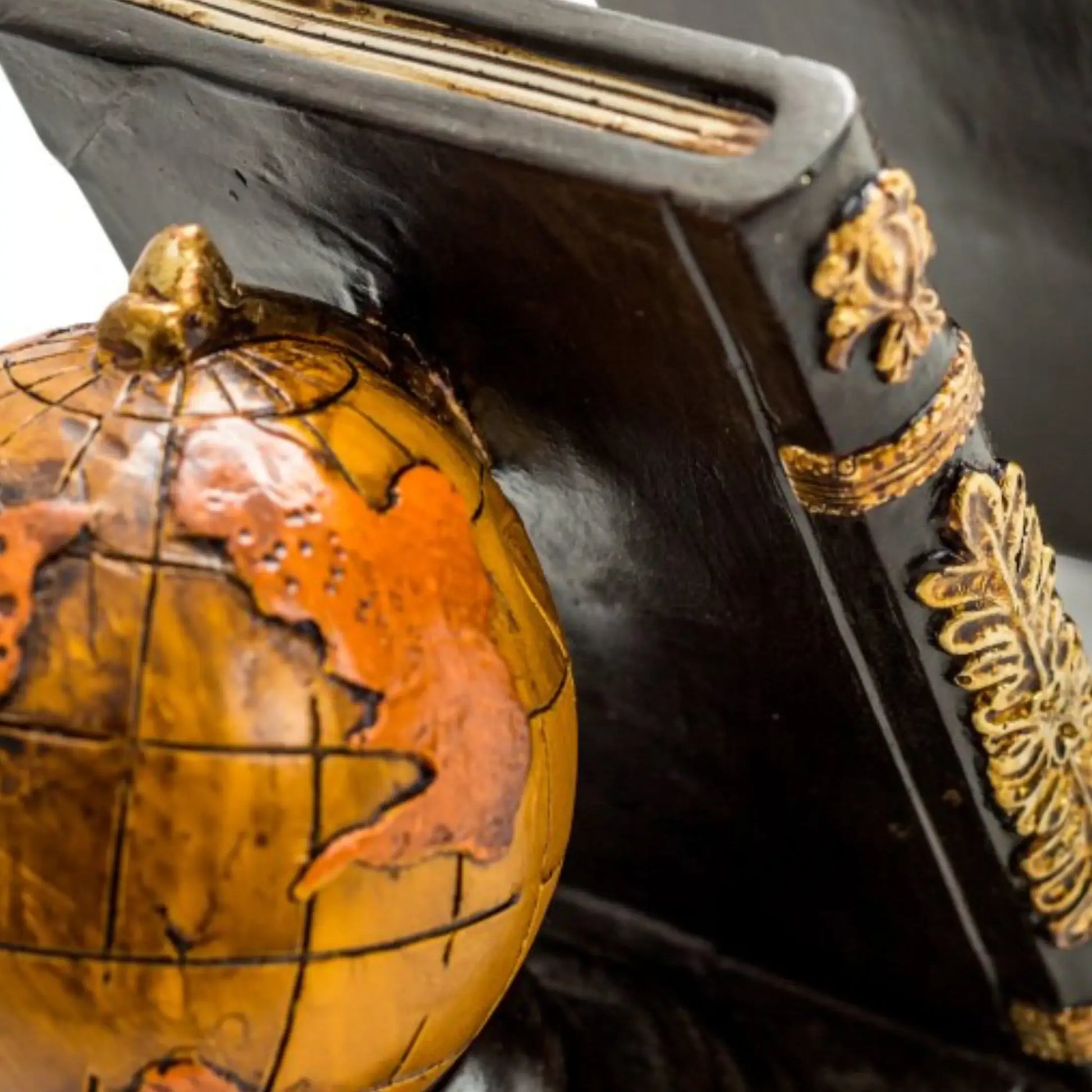 Decorative globe with intricate detailing on a dark background