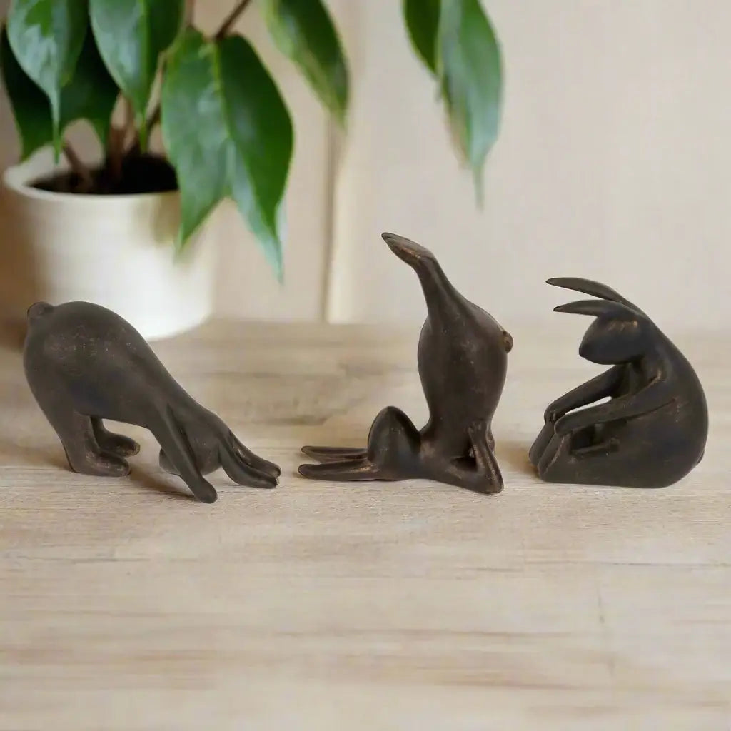 Three bronze seal figurines on a white background