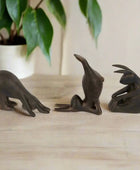 Three bronze seal figurines on a white background