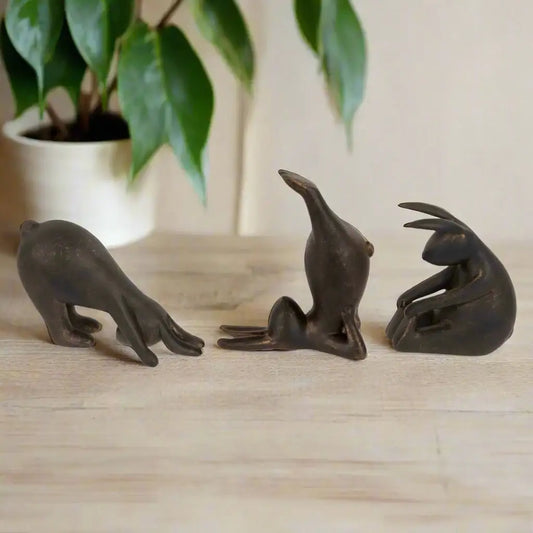 Three bronze seal figurines on a white background