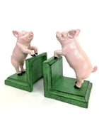 Two pig-shaped bookends on a white background