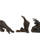Three bronze seal figurines on a white background