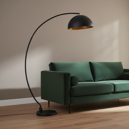 Green sofa with a black floor lamp against a beige wall