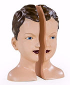 Mannequin head with split face for hairdressing training on a white background