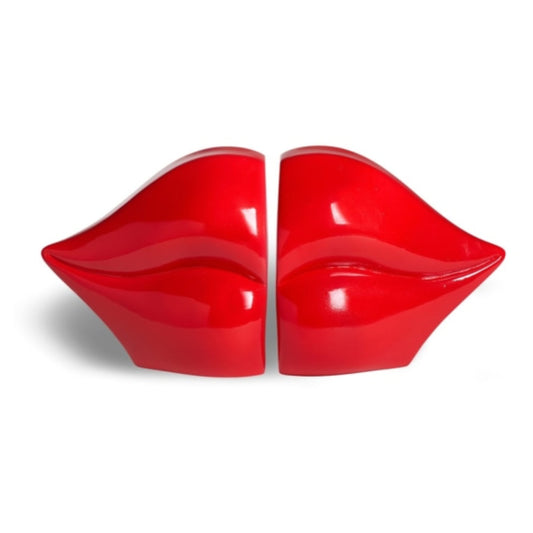 A pair of glossy red novelty chairs shaped like lips, set against a plain white background.