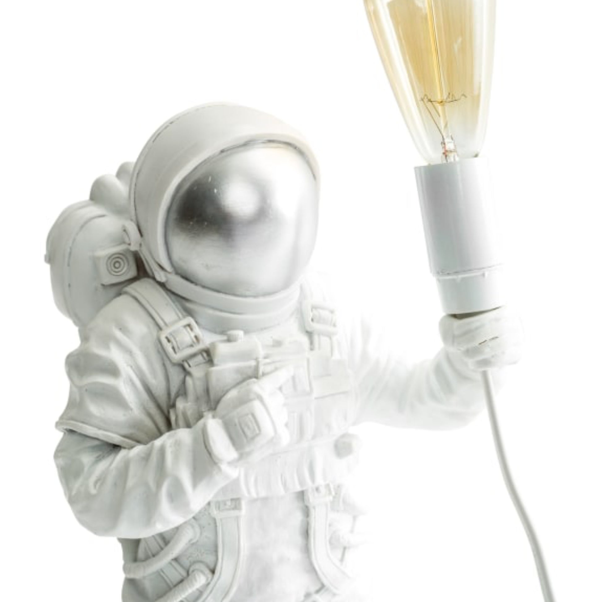 Astronaut figurine holding a light bulb against a white background