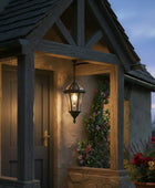Stone building with a lantern and flowers at dusk