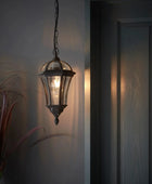 Decorative hanging light fixture on a wall next to a door