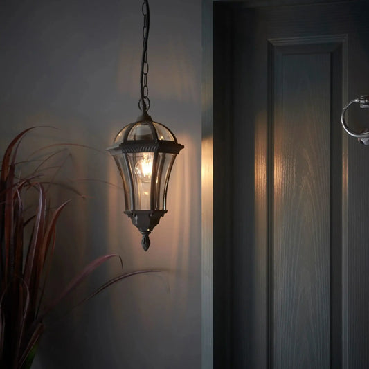 Decorative hanging light fixture on a wall next to a door