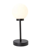 Table lamp with a black base and white shade on a white background