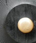 Gold button on a black textured background