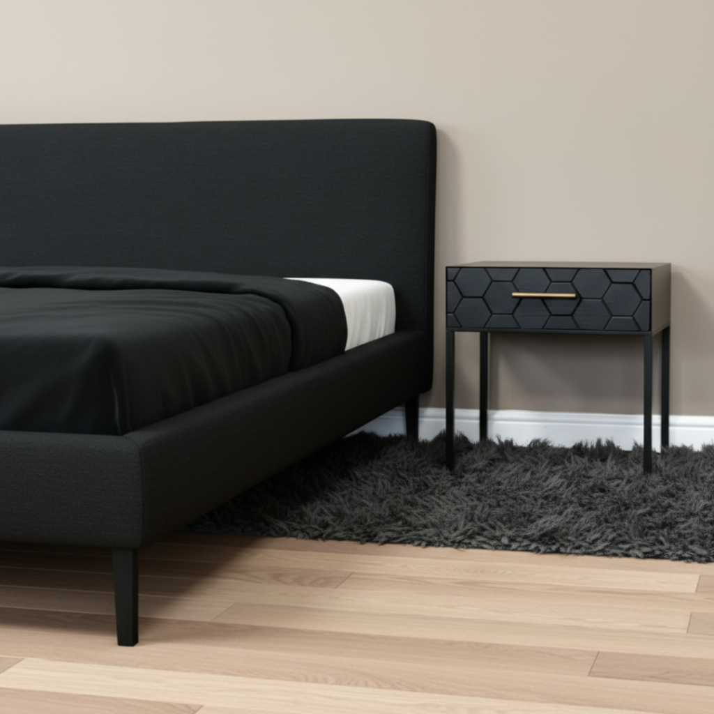 Modern bedroom with a black upholstered bed and hexagonal patterned nightstand.