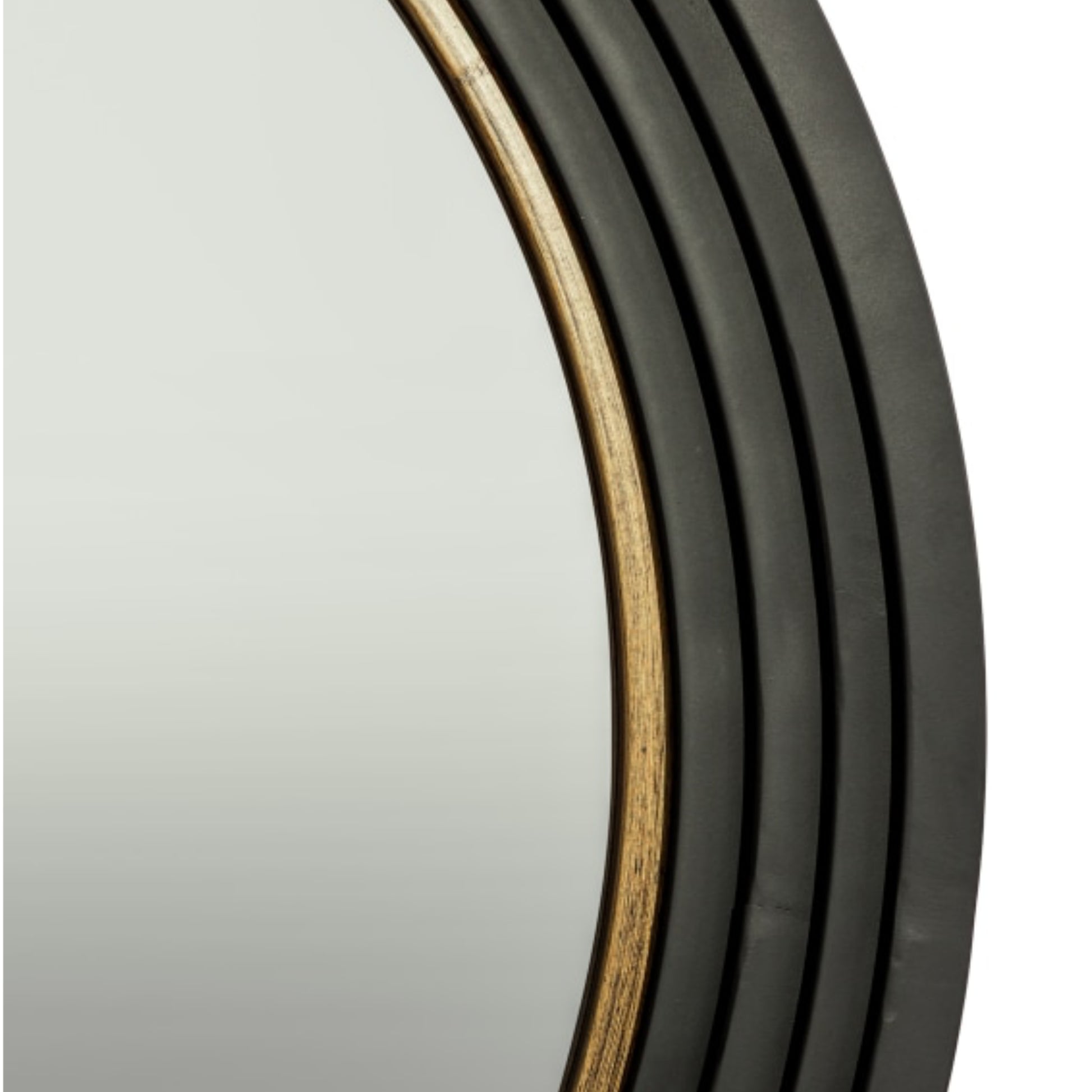 Close-up of a round wall mirror with a dark charcoal gray frame featuring a warm gold-toned inner trim.