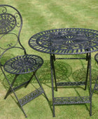 Black metal garden table and chairs on grass