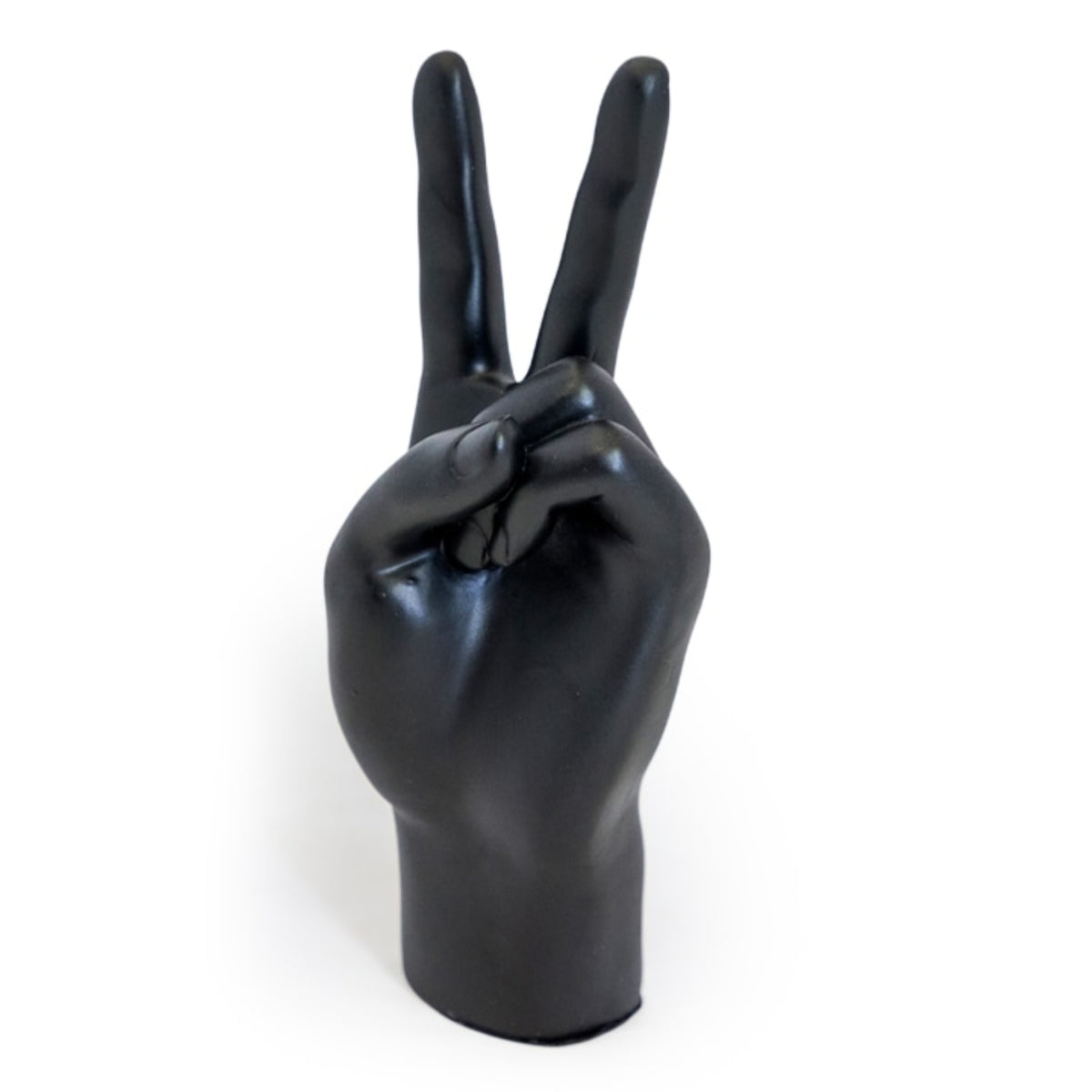 A glossy black hand sculpture or decorative object shaped like a human hand making a peace sign, photographed against a plain white background.