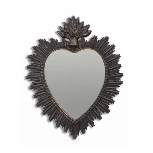 Heart-shaped mirror with decorative frame on a white background