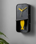 Wall clock with yellow fish design on a white background