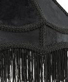 Close-up of a black fringed textile accessory with braided trim and hanging fringe, shown against a white background.