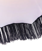 A close-up of a white fabric or material with a black fringe trim along the curved bottom edge, shown against a white background.