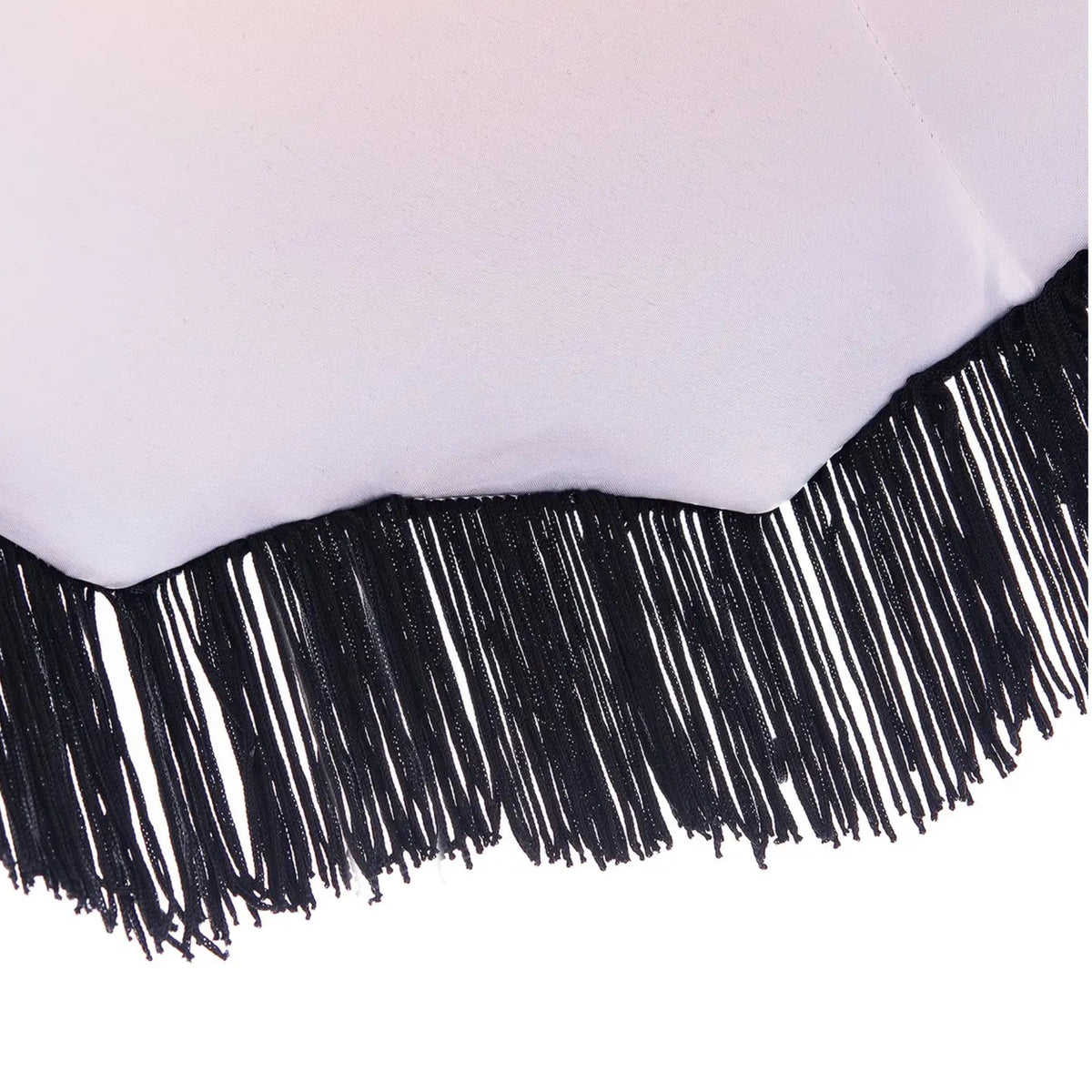 A close-up of a white fabric or material with a black fringe trim along the curved bottom edge, shown against a white background.