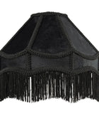 Black velvet and suede lampshade with intricate braided trim and a long fringe hanging from the bottom, shown against a plain white background.
