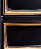 Close-up of a black and gold frame with a textured border