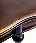 Close-up of a wooden chair with a metal frame on a white background