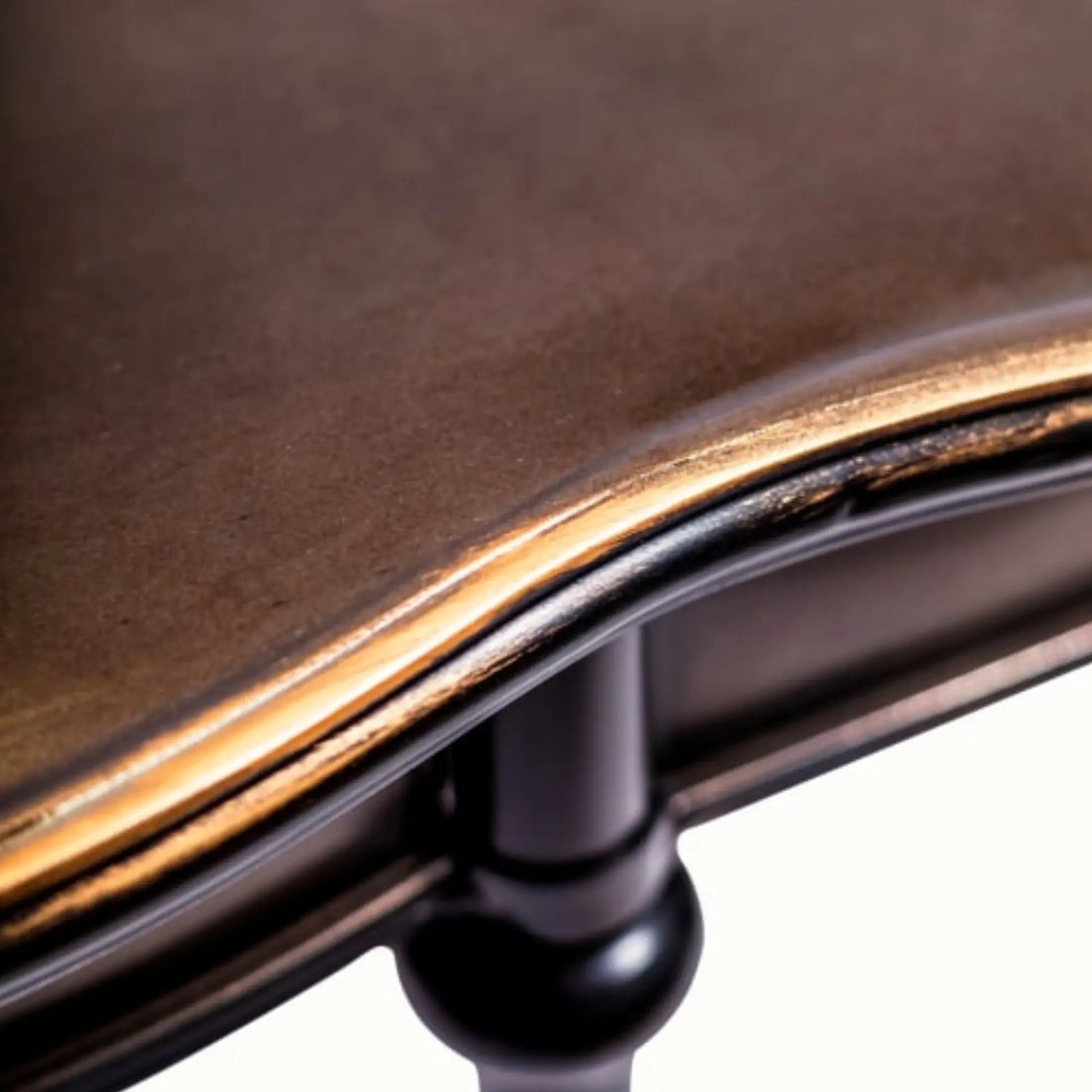 Close-up of a wooden chair with a metal frame on a white background