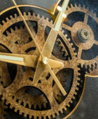 Close-up of a mechanical clock with gears and gold hands on a dark background