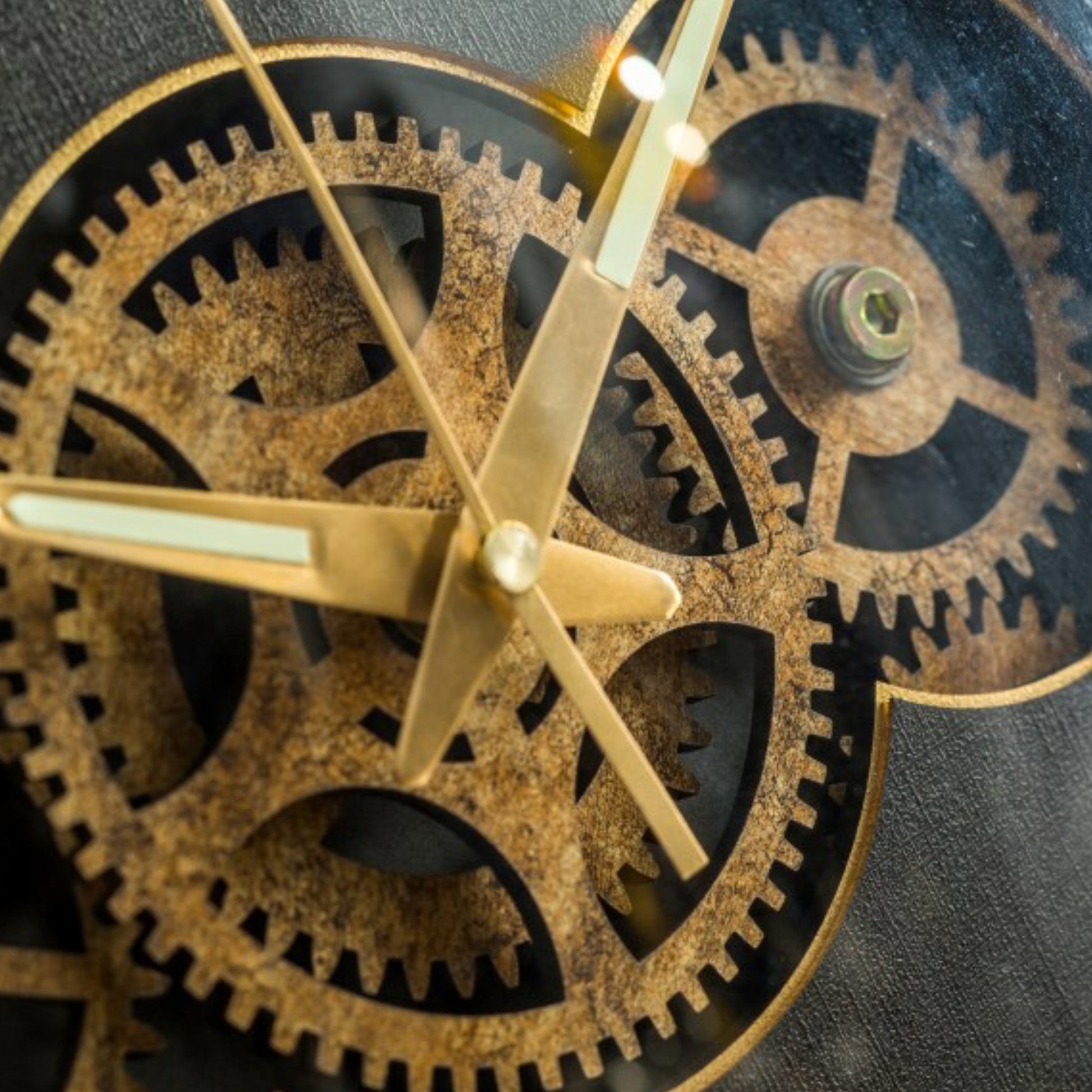 Close-up of a mechanical clock with gears and gold hands on a dark background