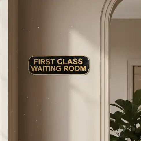 Door with a sign reading 'First Class Waiting Room' on a neutral background