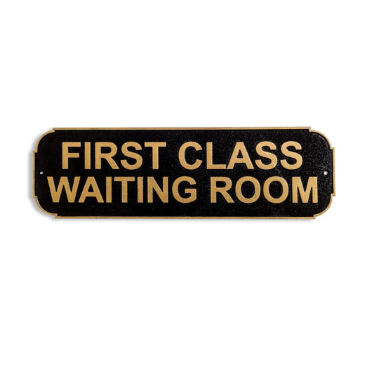 Sign reading 'FIRST CLASS WAITING ROOM' on a black background