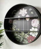 Round decorative shelf with floral design on a white wall