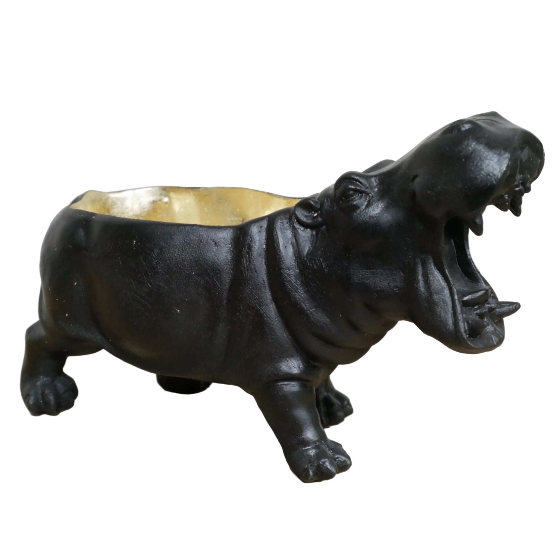 Black hippo-shaped candle holder on a wooden surface with a white background