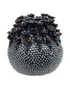 Decorative ceramic vase with textured surface and floral-like top on a white background