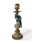 Decorative candle holder with bird design on a white background