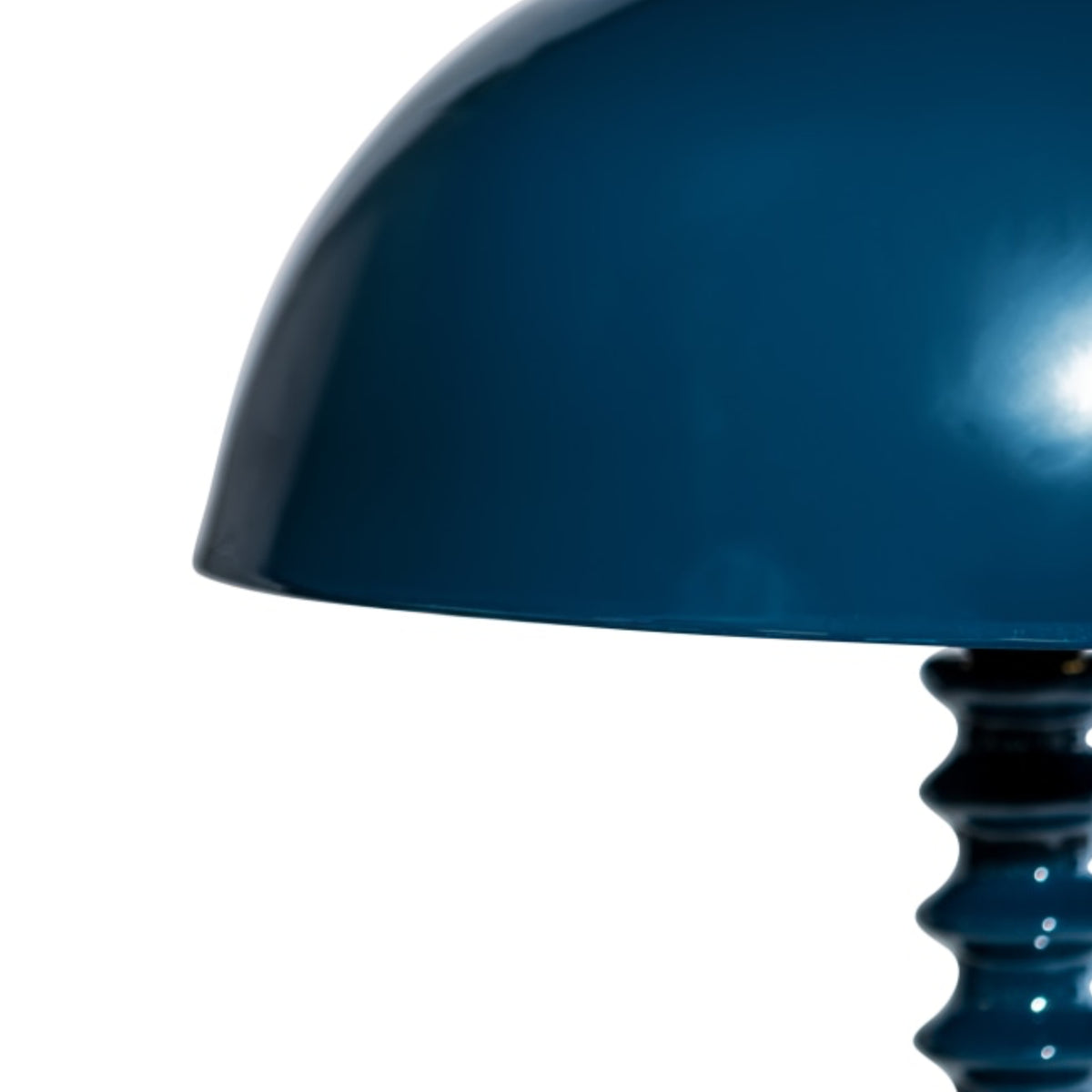 Close-up of a glossy dark teal-blue dome-shaped lampshade on a white background.