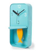 Blue clock with a yellow fish design on a white background