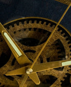 Close-up of mechanical clock gears with gold hands on a dark background