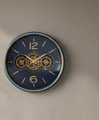 Wall clock with gear design on a beige wall