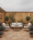 Outdoor patio with wicker furniture, plants, and a warm-toned wall.